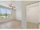 Bedroom showcasing neutral tile floors, view from the window and a walk-in closet at 5608 Pinnacle Heights Cir # 305, Tampa, FL 33624