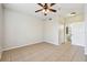 Neutral bedroom features tile flooring, a ceiling fan, and an ensuite bathroom with modern fixtures at 5608 Pinnacle Heights Cir # 305, Tampa, FL 33624