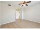 Neutral bedroom with ceiling fan and tiled flooring leads to an open doorway at 5608 Pinnacle Heights Cir # 305, Tampa, FL 33624