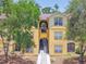 Inviting condo building featuring a neatly landscaped entrance and convenient stairway access to upper units at 5608 Pinnacle Heights Cir # 305, Tampa, FL 33624