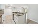 Kitchen featuring a breakfast bar, tile flooring, and an open layout at 5608 Pinnacle Heights Cir # 305, Tampa, FL 33624