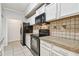 Bright kitchen with granite countertops, tiled backsplash, and stainless appliances at 5608 Pinnacle Heights Cir # 305, Tampa, FL 33624