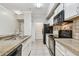 Clean kitchen with white cabinetry, black appliances, and tiled floor at 5608 Pinnacle Heights Cir # 305, Tampa, FL 33624