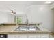 Kitchen featuring granite countertops, stainless steel sink, and view to the living room at 5608 Pinnacle Heights Cir # 305, Tampa, FL 33624