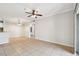 Open-concept living room with tile flooring, ceiling fan, and partial view of the kitchen at 5608 Pinnacle Heights Cir # 305, Tampa, FL 33624