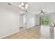 Inviting living area with balcony access, ceiling fan, and hallway leading to other rooms at 5608 Pinnacle Heights Cir # 305, Tampa, FL 33624