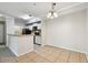 Open-concept living area with tile floors, white walls, and a kitchen bar in the background at 5608 Pinnacle Heights Cir # 305, Tampa, FL 33624