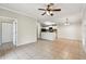 Open-concept living space with tile floors seamlessly connects the living area to the adjacent kitchen at 5608 Pinnacle Heights Cir # 305, Tampa, FL 33624