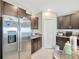 Kitchen with stainless steel refrigerator and dark brown cabinets at 9433 Channing Hill Dr, Sun City Center, FL 33573