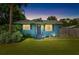 Charming light blue house with a well-manicured lawn and mature trees at 6030 62Nd N St, St Petersburg, FL 33709