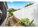 Landscaped side yard with a walkway and raised garden bed at 6030 62Nd N St, St Petersburg, FL 33709