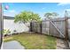 Small, fenced backyard with a tree and garden area at 6030 62Nd N St, St Petersburg, FL 33709