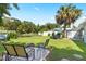 Large backyard with patio, fire pit, and lush landscaping at 6030 62Nd N St, St Petersburg, FL 33709