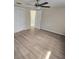 Spacious main bedroom with wood-look floors and ceiling fan at 3913 Claremont Dr, New Port Richey, FL 34652