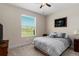 Bedroom with lake view, a queen-size bed, and window blinds at 19879 Tattnall Way, Brooksville, FL 34601