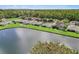 Aerial view of lakefront homes and green landscape at 19879 Tattnall Way, Brooksville, FL 34601