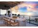 Outdoor balcony with dining area and sunset ocean views at 10126 Gulf Blvd # Ph4, Treasure Island, FL 33706