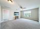 Spacious bedroom featuring neutral tones, a ceiling fan, and a large window for natural light at 11828 Ranchers Gap Dr, Odessa, FL 33556