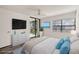 Bright bedroom featuring a calming ambiance, balcony access, and a light color scheme at 14130 Rosemary Ln # 2208, Largo, FL 33774