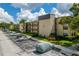 Exterior view of a building in a community with parking and well-maintained landscaping at 14130 Rosemary Ln # 2208, Largo, FL 33774