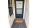 Front door with 'Welcome Home' mat, offering a warm and inviting entrance at 14130 Rosemary Ln # 2208, Largo, FL 33774