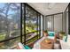 Cozy sunroom with views of the landscaped grounds and serene lake, perfect for relaxation at 14130 Rosemary Ln # 2208, Largo, FL 33774
