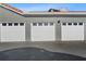 Three-car garage with white garage doors at 18001 Richmond Place Dr # 122, Tampa, FL 33647