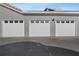 Three-car garage with white garage doors at 18001 Richmond Place Dr # 122, Tampa, FL 33647