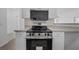 Modern kitchen with stainless steel appliances and light cabinets at 18001 Richmond Place Dr # 122, Tampa, FL 33647