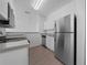 Modern kitchen with stainless steel appliances and light cabinets at 18001 Richmond Place Dr # 122, Tampa, FL 33647