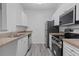 Bright kitchen featuring stainless steel appliances and white cabinets at 18001 Richmond Place Dr # 511, Tampa, FL 33647