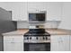Updated kitchen, featuring stainless steel appliances and white cabinets at 18001 Richmond Place Dr # 511, Tampa, FL 33647