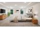 A staged primary bedroom features ample natural light, recessed lighting, and cozy carpet at 4013 Chadwick Ave, Spring Hill, FL 34609