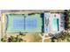 Aerial view of the community pool, tennis court, spa, and cabana at 651 Garland Cir, Indian Rocks Beach, FL 33785