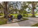 Relaxing BBQ area with seating under large shade tree at 14130 Rosemary Ln # 2208, Largo, FL 33774