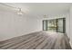 Spacious living room with sliding doors to balcony and wood-look flooring at 14130 Rosemary Ln # 2208, Largo, FL 33774