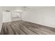Spacious living room with wood-look flooring and access to kitchen at 14130 Rosemary Ln # 2208, Largo, FL 33774