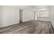 Open living area with wood-look floors and view into kitchen at 14130 Rosemary Ln # 2208, Largo, FL 33774
