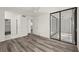 Spacious bedroom with wood-look floors and access to a screened balcony at 14130 Rosemary Ln # 2208, Largo, FL 33774