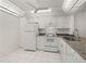 Updated kitchen with white cabinets and granite countertops at 14130 Rosemary Ln # 2208, Largo, FL 33774
