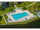 Community pool with surrounding patio and seating at 14130 Rosemary Ln # 2208, Largo, FL 33774