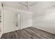 Bedroom with wood-look floors and access to bathroom at 14130 Rosemary Ln # 2208, Largo, FL 33774
