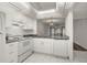 White kitchen cabinets, granite countertops, and stainless steel appliances at 14130 Rosemary Ln # 2208, Largo, FL 33774