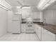 Well-equipped kitchen featuring white cabinets and granite counters at 14130 Rosemary Ln # 2208, Largo, FL 33774