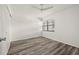 Bright bedroom featuring wood-look flooring and ceiling fan at 14130 Rosemary Ln # 2208, Largo, FL 33774