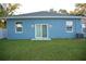 Rear view of a charming blue house with sliding glass doors at 3301 Lila St, Tampa, FL 33610