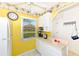 White kitchen with yellow walls and appliances at 1619 Mission Hills Blvd, Clearwater, FL 33759