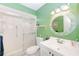 Green bathroom with a shower and white vanity at 1619 Mission Hills Blvd, Clearwater, FL 33759