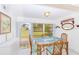 Charming dining area with glass table and view of the backyard at 1619 Mission Hills Blvd, Clearwater, FL 33759