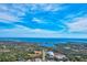Aerial view showcasing waterfront property with distant city skyline at 1619 Mission Hills Blvd, Clearwater, FL 33759